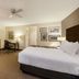 La Quinta Inn & Suites by Wyndham Cleveland Macedonia guest room with bed, desk, TV and chair