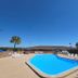 Super 8 by Wyndham Lake City outdoor pool with lounge chairs under a clear blue sky