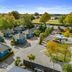 Tasman Holiday Parks - Christchurch with blue cabins and tree-lined park setting in Christchurch