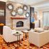 Courtyard by Marriott Pueblo Downtown lobby with seating area, brick fireplace, and large windows
