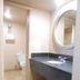 Airport Inn Downtown Phoenix bathroom with sink vanity, mirror, and adjoining toilet room