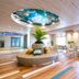 La'gent Hotel Okinawa Chatan lobby with circular sofa, tropical ceiling art and bright seating area