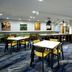 Fairfield Inn by Marriott Greensboro Airport breakfast area with tables, chairs and buffet in Greensboro