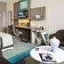 Golden Tulip Aix Les Bains guest room with bed, desk, chair and seating area in Aix-les-Bains