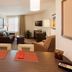 Candlewood Suites Morgantown-Univ West Virginia lobby suite with sofa, TV, desk and dining table