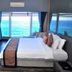 Sinclairs Bayview in Port Blair with a king bed and desk overlooking the ocean through large windows