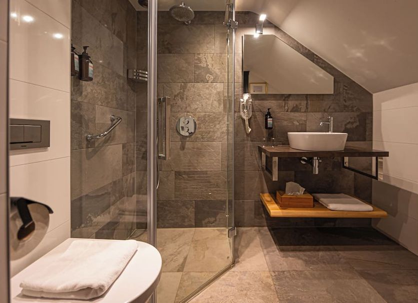 Bathroom at Buitenplaats Kasteel Elsloo in Stein with walk-in shower, vessel sink and heated towel rail