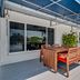 4145 By The Sea Inn & Suites in Lauderdale-by-the-Sea: covered deck with dining table and lounge chairs