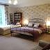 Manor Farm B&B in Marlborough guest room with wrought-iron bed, sofa and floral wallpaper