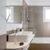 Hotel Sant Roc bathroom with tub, glass shower, double sink, and towels in Calella de Palafrugell