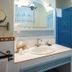 Marulivo Hotel, Pisciotta: bright bathroom with sink, mirror, blue tiled shower and heated towel rail
