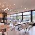 Minamisenri Crystal Hotel in Suita dining area with large windows and bright modern seating