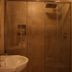 B&B Gildo Trani bathroom with sink, mirror and glass shower enclosure in Trani