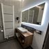 Hotel Am Schloss Ahrensburg bathroom with sink vanity, heated towel rail, toilet and mirror