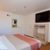 Motel 6 Twentynine Palms guest room with king bed, wall-mounted TV, and open closet