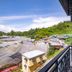 Nova Highlands Hotel in Brinchang with balcony view of green hills and rooftops