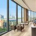 Hilton Saigon bar lounge with floor-to-ceiling windows and city skyline views in Ho Chi Minh City
