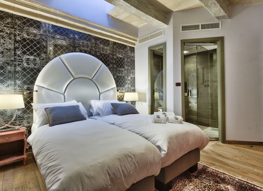 Palazzo Consiglia - Ik Collection in Valletta guest room with twin beds, skylight, and ensuite glass shower