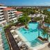 Dreams Aventuras Riviera Maya in Puerto Aventuras with lagoon pool, palm trees and ocean view