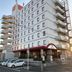 Wing Izumi hotel in Izumi with a multi-story exterior and balcony-lined side facade