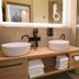 Waldhotel am Notschreipass bathroom in Todtnau with double vessel sinks and glass shower