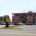 Gulf Towers Resort Motel in Indian Rocks Beach, pink beachfront hotel with palm trees and parking lot