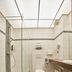 Threeland Hotel Pétange bathroom with walk-in shower, wall-mounted toilet and vanity