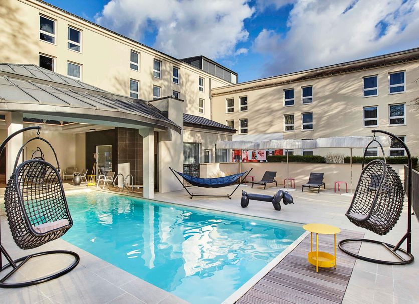 Mercure Château de Fontainebleau Demeures de Campagne outdoor pool with hanging chairs and loungers in Fontainebleau