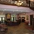 Hearthstone Elegant Lodge by the River lobby with staircase, chandelier, stone fireplace and seating in Kamiah