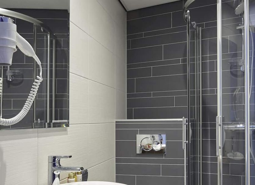 The Muse Amsterdam Boutique Hotel bathroom with walk-in shower and handheld showerhead in Amsterdam