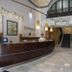 Cuatro Naciones Barcelona hotel lobby with curved front desk and staircase