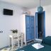 Camere D'Aragona in Otranto: simple guest room with twin beds, desk, wardrobe and blue bathroom doorway