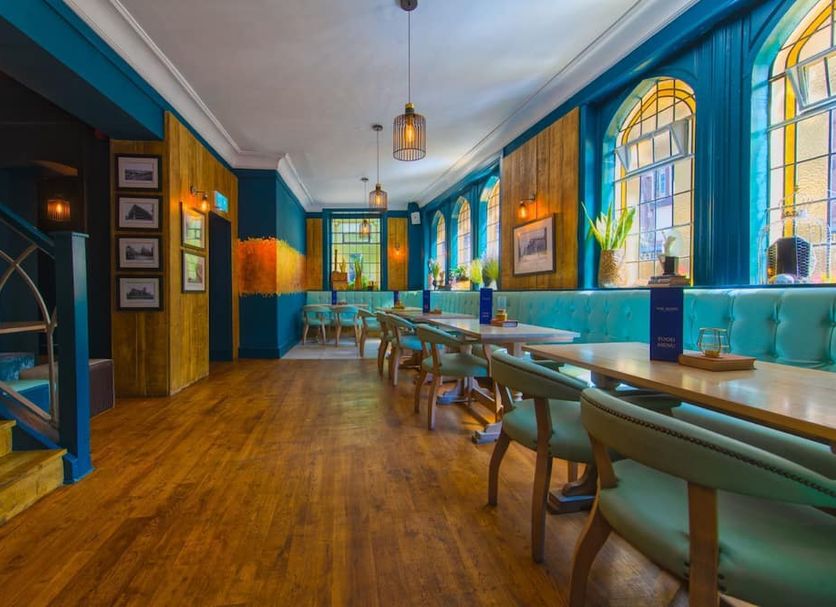 Mitre Hotel Manchester City Centre dining room in Manchester with blue walls, arched windows and wooden tables