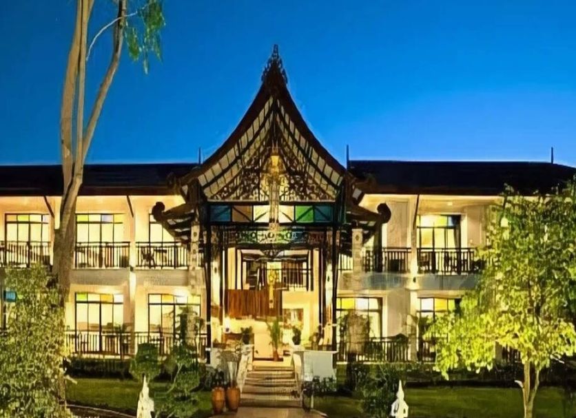 Radateeree Boutique Resort in Chiang Mai at night, showing a lit Thai-style entrance and garden