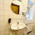 Garni-Hotel Adler in Ostfildern bathroom with sink, mirror, wall-mounted toilet and window