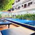 Golden Bakong Boutique Siem Reap poolside lounge chairs beside outdoor pool and hotel building