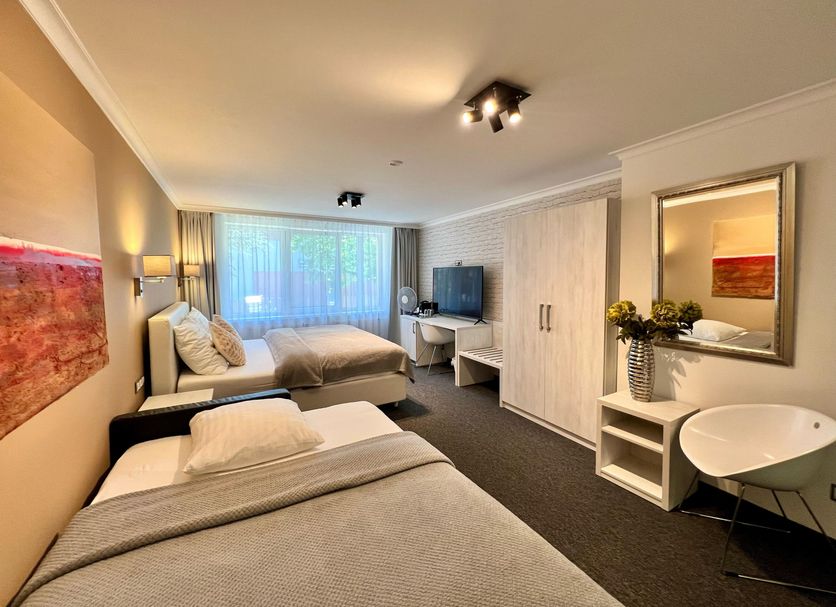 Grand Petit Hotel ex Shato Gesson in Prague guest room with two beds, desk, wardrobe and sink