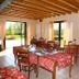 La Perla del Sile Country House in Silea: rustic dining room with tables and garden-facing windows