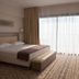 Villa Azur room in Villeneuve-Loubet with king bed, desk, and large window with sheer curtains