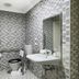 The Phoenix Artesian Spa Resort and Accommodation bathroom in Moree with tiled walls, sink, toilet and grab bars.