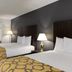 Baymont by Wyndham Branford/New Haven guest room with two beds and desk in Branford