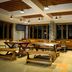Hotel Tibera Taman Cibeunying in Bandung dining area with wooden picnic tables and pendant lights