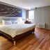 ibis Haguenau Strasbourg Nord guest room with double bed, wood floors and a small window in Haguenau