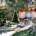 Hotel La Fayette Licola in Giugliano in Campania: garden patio with tables, chairs and a large tree