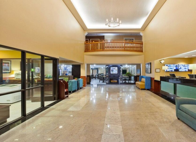 Holiday Inn Express & Suites Canton lobby with seating area, front desk, and mezzanine view