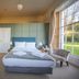Laston House, Ilfracombe: bright guest room with large bed, tall windows, and garden view