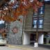 Hosteria Posta de los Colonos in Villa La Angostura, stone hotel facade with autumn leaves
