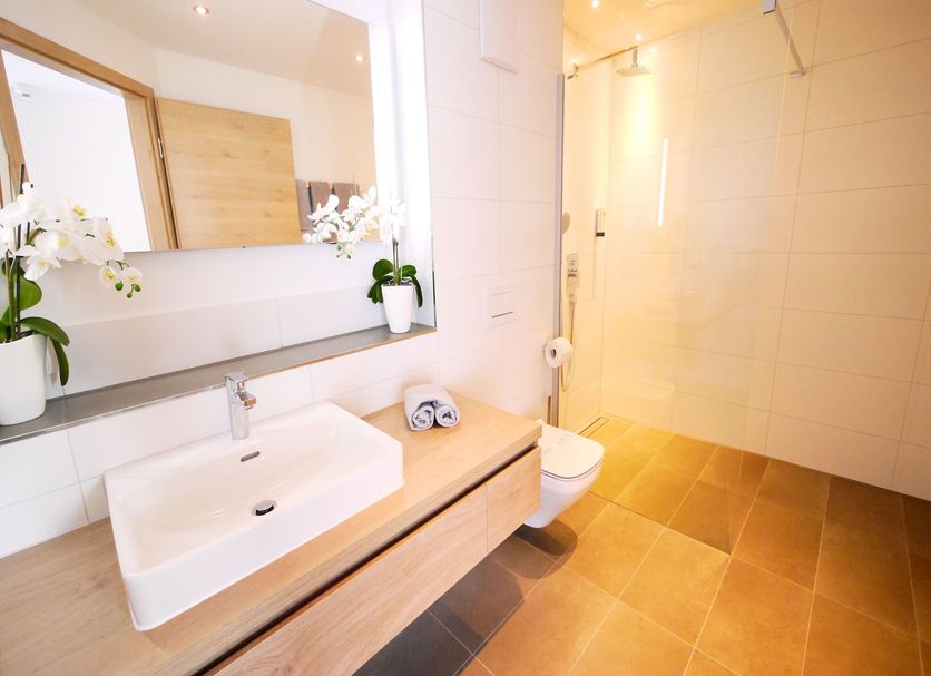Kohlers Hotel Engel in Bühl bathroom with sink vanity, mirror and walk-in shower