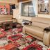 Super 8 by Wyndham Jacksonville lobby seating area with tan sofas and patterned carpet