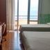 Hotel Glavjc in Torno room with two beds, balcony door, and lake view